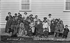 Northern British Columbia Indian Children - lady in back row to right is Mrs. Vicky Aldows - then Miss Vicky Morrison daughter to Hudson Bay co. Manager. She is now living in Victoria, B.C 1910