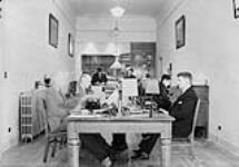 Canadian National Telegraph Office - 500 Blk and 3rd Avenue West - first man on left is Bill Davies and second man is W.W. Wrathall, man on the right sitting is Mr. Schubert 1935