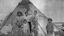 [Cree woman and children and their summer home] Original title: Natives and their summer home July 1927.