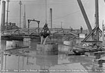 New Cherry St. Bridge, dredging inside caisson with "Orange Peel" bucket, Toronto, Ont Mar. 31, 1916