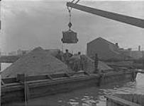 Empty bucket returning from concrete mixer, Cherry St. bridge, Toronto, Ont July 3, 1916