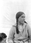 Woman with long braids sitting beside a small boy [The woman has been identified as Kajurjuk] July 1926.