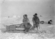 [Two Inuit with dog sled on a trail] Original title: Native sled on trail 1926