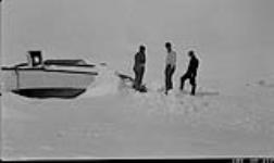Looking over the motor schooner "Hawk" in winter quarters. Fred Barnes, Bill Storr and Fred Seeley 1931