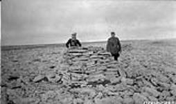 [Frank Start and Sgt. J.E.F. Wight beside an old Inuit fox trap] Original title:Frank Start and Sgt. J.E.F. Wight beside old Eskimo fox trap 1929