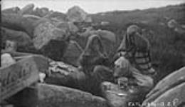Inuit women having a smoke of powdered reindeer moss 1930