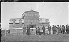 Bishop Breynat's residence at Fort Resolution. Bishop Breynat and Inspector Fletcher of the Royal Canadian Mounted Police (R.C.M.P.) standing to left 1920