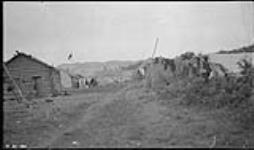 [Houses belonging to Dene community members at Tulita] Original title: Indian homes at [Fort] Norman 1920