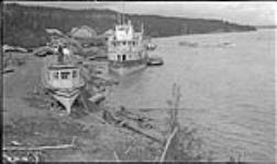 Dominion Government Forest fire boat on bank, and Hudson's Bay Company's steamer "Mackenzie River" in water 1920