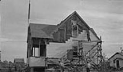 Warden's house under construction (side view) R.C.C.S. building in rear 1946