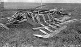 Old Inuit grave at Atkinson Point Arctic Sea Coast, built of driftwood. Remains of sleds and weapons 1928