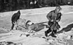 Russ Baker (right) and Pierre Berton hauling fuel to the aircraft 1947