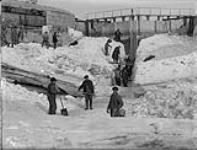 Soulanges Canal Guard gate, view of upper side of gate showing cut in ice on centre line of canal Mar. 10, 1920