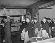 Group of newspaper editors touring galley of H.M.C.S. "Stadacona" 30 Aug. 1941