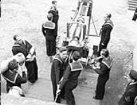 Unidentified ratings practising the loading and firing of a six-inch gun, Royal Canadian Navy Gunnery School, Halifax, Nova Scotia, Canada, 1940 1940.