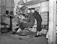 Unidentified rating being trained in the operation of a .50-calibre anti-aircraft gun, H.M.C.S. CORNWALLIS, Halifax, Nova Scotia, Canada, 21 October 1942 October 21, 1942.