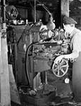 Machinist working in the Electrical Artificers' Workshop, H.M.C. Dockyard, Halifax, Nova Scotia, Canada, 18 November 1942 November 18, 1942.