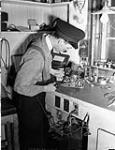 An Electrical Artificer working on a radio set in the Electrical Artificers' Workshop, H.M.C. Dockyard, Halifax, Nova Scotia, Canada, 18 November 1942 November 18, 1942.