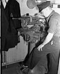 A Chief Electrical Artificer operating a power drill in the Electrical Artificers' Workshop, H.M.C. Dockyard, Halifax, Nova Scotia, Canada, 18 November 1942 November 18, 1942.