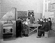 Bricklaying class at the Mechanical Training Establishment, H.M.C.S. CORNWALLIS, Halifax, Nova Scotia, Canada, 18 January 1943 January 18, 1943.
