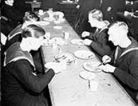 [Personnel of the Royal Navy eating at the North End Services Canteen. (Left to right): Tel. R. Wall, ABs R. Teece, C. Salter.] 6 Feb. 1943