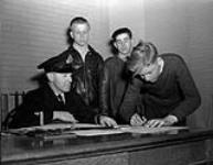 Boys signing application forms to join the Nelson Sea Cadet Corps, Halifax, Nova Scotia, Canada, 23 March 1943 March 23, 1943.
