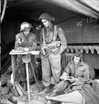 Unidentified personnel of the Canadian Armoured Corps (C.A.C.) using wireless signal information to plot enemy movements in the Normandy beachhead, France, 6 June 1944 June 6, 1944.