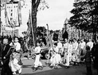 Chinese residents from Ottawa, Montreal and Toronto hold parade in celebration of the official V-J Day and the fourth anniversary of the Chinese Free Mason lodge. 