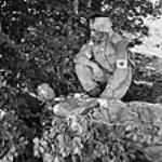 Captain A.W. Hardy, Edmonton, AB, Medical Officer with the West Nova Scotia Regiment, lying wounded, with Pte. W.E. Dexter, a unit stretcher-bearer who was wounded in the head, Santa-Cristina D'Aspromonte, Italy, 8 September 1943 September 8, 1943.