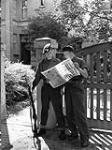 Personnel of the Canadian Army Occupation Force reading the news of the surrender of Japan, Westerstede, Germany, 16 August 1945 August 16, 1945.