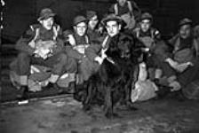 Infantrymen of "C" Company, Royal Rifles of Canada, and their mascot en route to Hong Kong. Vancouver, British Columbia, Canada, ca. 27 October 1941 [c.a. Otober 27, 1941]