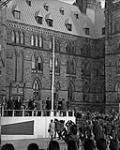 [Lowering the Ensign at the ceremony for raising the new flag, Parliament Hill, Ottawa, Ont.] [15 February 1965].