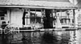 I.B. York's store and post office, showing the Gatineau River in flood 1908