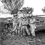 Tank crew of the Three Rivers Regiment with a German PzKpfW IV tank, which they destroyed, Termoli, Italy, 9 October 1943 October 9, 1943.