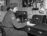 Signalman J.T. Prime of 1st Canadian Army Signals, Royal Canadian Corps of Signals (R.C.C.S.), operating a local radio receiver and remote unit, Zeddam, Netherlands, 4 April 1945 April 4, 1945.