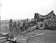 Gunners of a Medium Regiment of the Royal Canadian Artillery (R.C.A.) cleaning a 5.5-inch gun south of Vaucelles, France, 23 July 1944 July 23, 1944.
