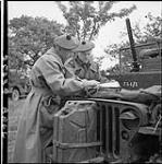 Officers of the Highland Light Infantry of Canada examining map. (Left to right): Lt. Col. F.M. Griffiths, Lt. G.D. Campbell 20 June 1944