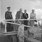 Major-General the Hon. Georges P. Vanier shaking hands with tractor driver Jack Hardy June 1961