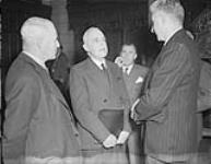 Newfoundland and Canadian Government delegations after the inaugural meeting in the Senate Chamber. L. to R. : Hon. J. J. McCann; Rt. Hon. L. S. St.Laurent; J. B. McEvoy and Hon. A. J. Walsh Oct. 1948
