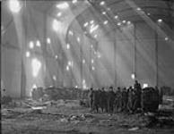 Troops of 49th British Divn inside damaged factory 13 Apr. 1945