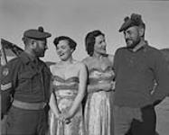 "U.K. Accent Laughter" show on tour; Ann Black and Stella Moray admiring beards of Sgt. Bruce MacLean and Pte. Amero of the Royal Highlanders of Canada Pioneer Platoon 21 Nov. 1953