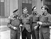 Corporal T.C. Mackenzie, Sergeant R.W. Williams, Private N.E. Smith and Gunner H.D. Gugell, who all received Military Medals, at Buckingham Palace, London, England, 27 June 1945 June 27, 1945