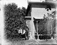 Side of brick house with verandah [between 1889-1916]