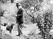 J.B. [James Ballantyne] and dogs [between 1889-1916]