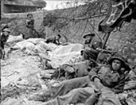 Wounded Canadian soldiers awaiting evacuation to a Casualty Clearing Station of the Royal Canadian Army Medical Corps (R.C.A.M.C.) in the Normandy beachhead, France, 6 June 1944 June 6, 1944.