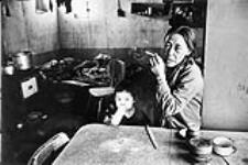 Woman & child inside a house [graphic material] 1968