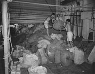 L/Steward Jack York handles mail distribution on H.M.C.S. UGANDA of British Pacific Fleet 6 Aug. 1945