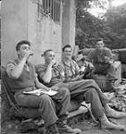 Infantrymen of The North Nova Scotia Highlanders celebrating the entry into Vaucelles with some French wine, Vaucelles, France, 20 July 1944 July 20, 1944.
