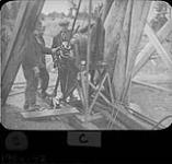 MOOSE RIVER MINE RESCUE. The diamond drill and crew. Billy Bell is probably standing at left in the operator's position Apr. 1936