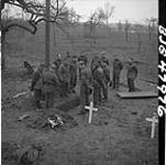 No. 2 Canadian Army Film and Photo Unit members at burial of Sgt. H.A. Barnett. Xanten (vicinity), Germany, 12 March 1945 12 Mar. 1945